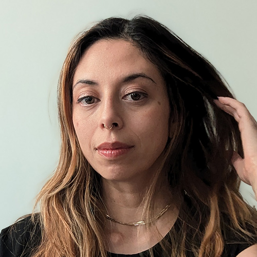 headshot of woman with dark brown hair and medium brown skintone